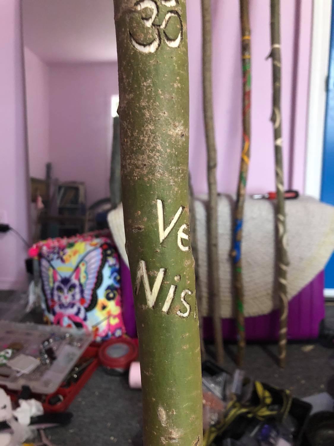Part of the husband's name carved into the side, and wrapping around.