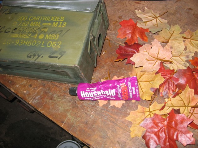 The canister beside the leaves, with a bottle of strong glue between.