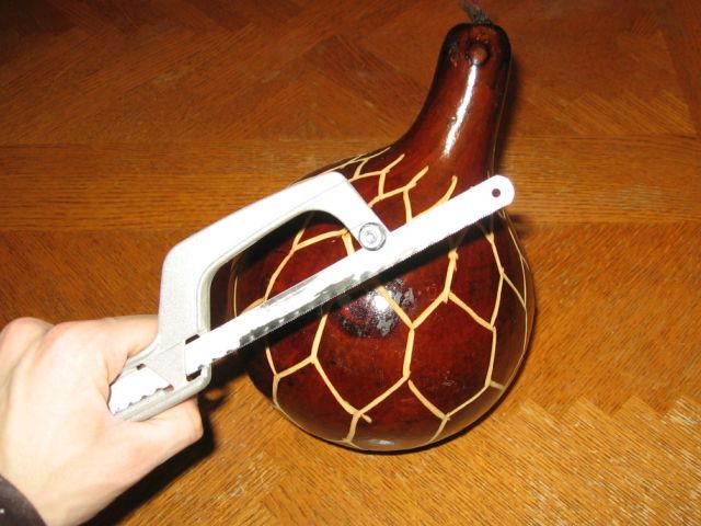 The gourd with a small hand saw in front.