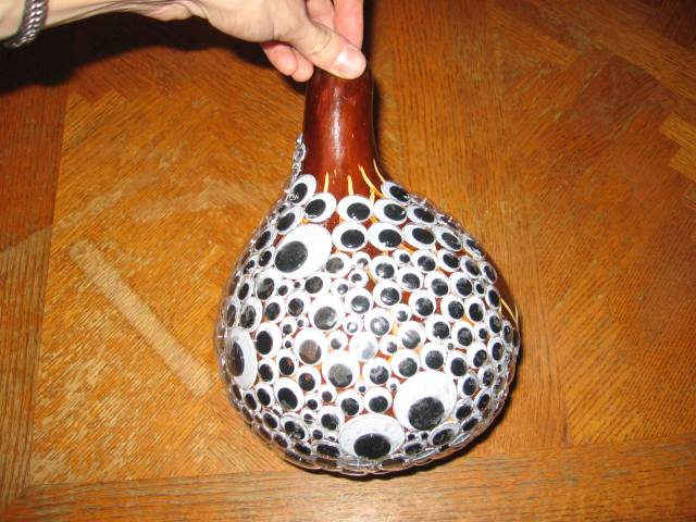 The gourd mostly covered in googly eyes.