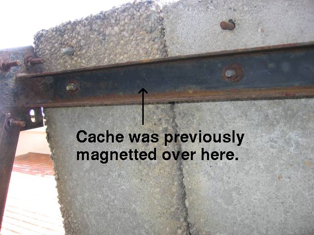An arrow pointing at a piece of steel u-joint, and an arrow saying that the geocache had previously been located at that spot.