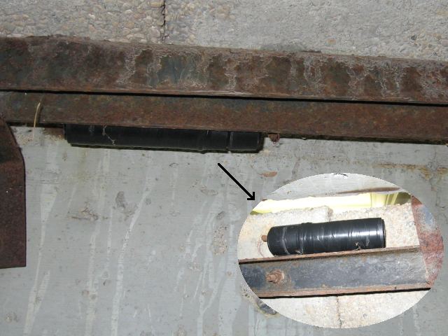The container hiding underneath the metal structure.