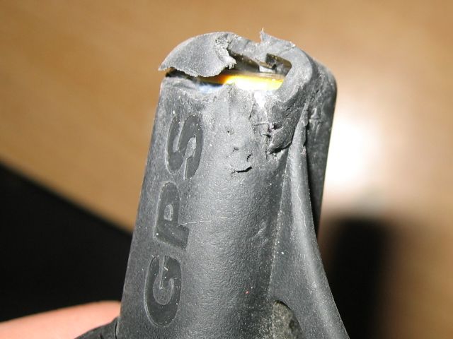 A closeup showing the hole in the antenna and the yellow plastic beneath