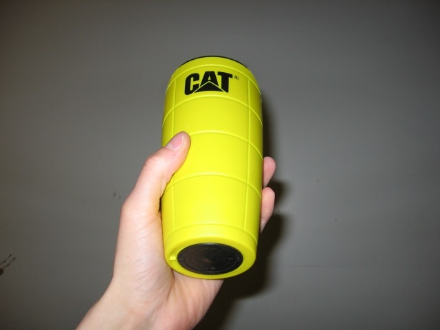Kabutroid holding up a yellow travel coffee mug.