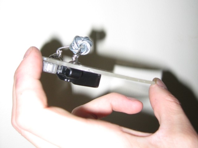 The underside of the acrylic with a large chainmaille mobius ball attached.