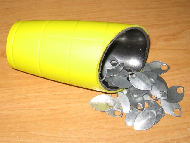 The cup on its side with a pile of steel scales pouring out.
