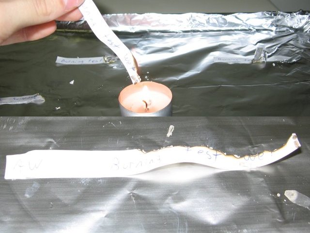 The all weather paper, burning much better than the regular paper, mainly along the edge of the strip.
