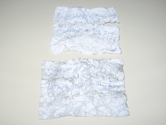 The two papers, heavily crumpled and flattened out again, with the regular paper having rips and tears, and the all weather holding together. The text on the regular paper held up better than on the all weather though.