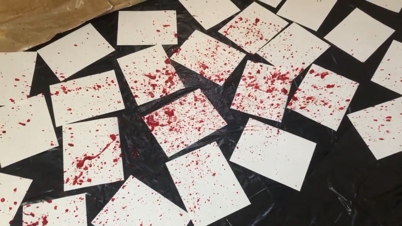 Oh my god. What happened here? Strewn about paper, and blood everywhere. It's hard to describe. No but seriously the room is covered in papers strewn about overtop of black garbage bags, and blood is sprayed across it. It's.... a horrorshow.