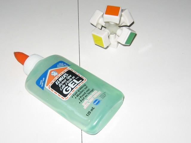 A bottle of elmers glue, beside the disassembled core.