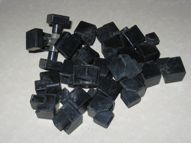 All of the pieces of the cube disassembled and sitting in a pile.