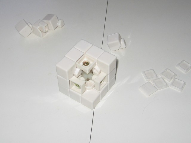 Most of the pieces placed onto the cube, with only one corner remaining.