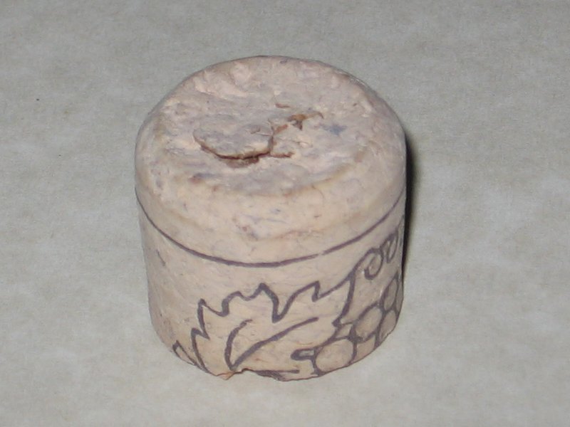 A piece of a cork, cut off and sitting on the countertop.