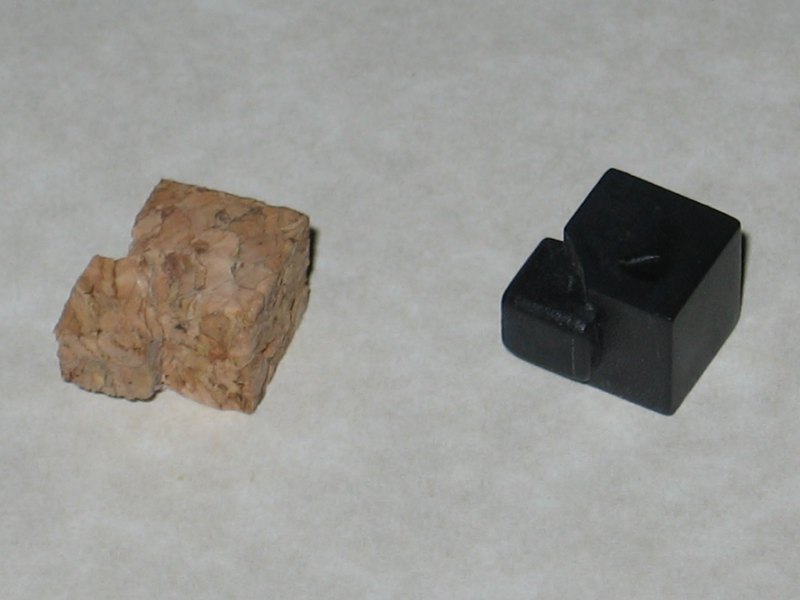 A duplicate piece to the one needed made from cork, sitting beside the real thing.