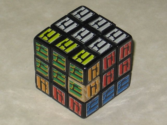 The cube assembled, with all of the stickers being the Metroid floor tile, in the varying, scrambled colours.