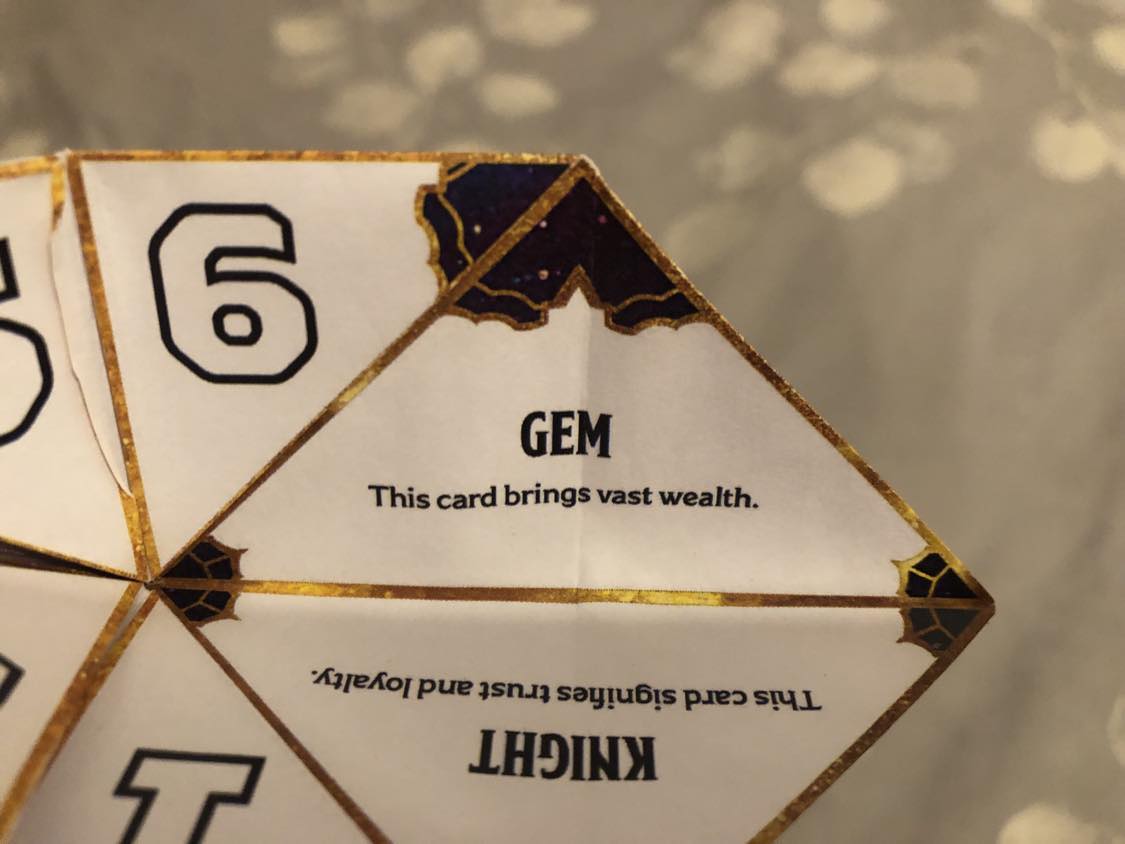 The fortune teller open to your fortune. 7, Gem. This card brings vast wealth.